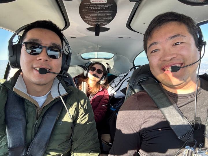 The ThisLounge founders wearing headsets in a small plane